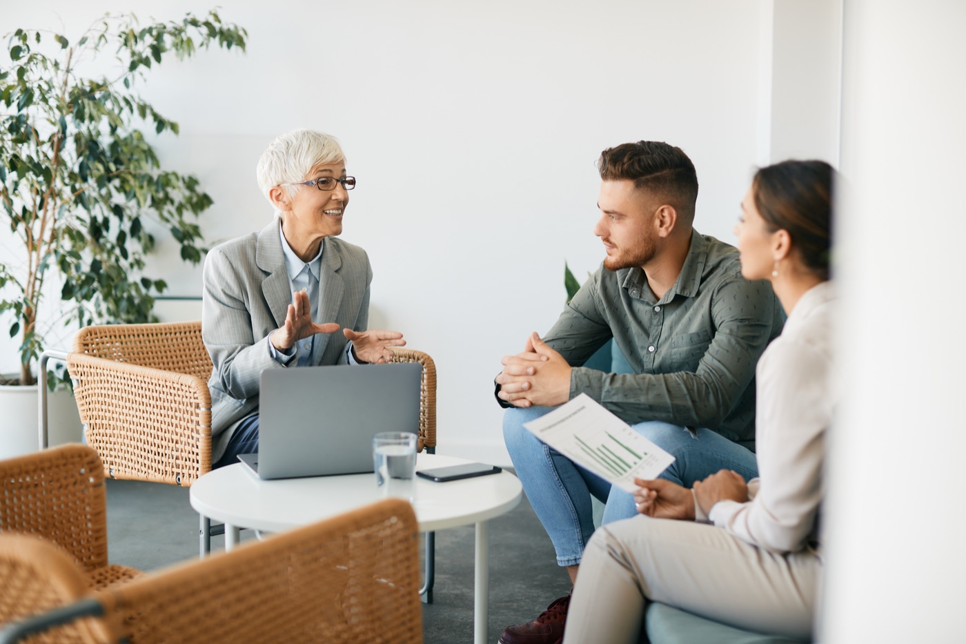 A financial adviser explaining reverse mortgage options to a senior couple