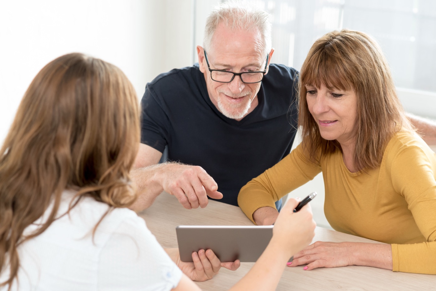 A senior couple meeting with their real estate professional